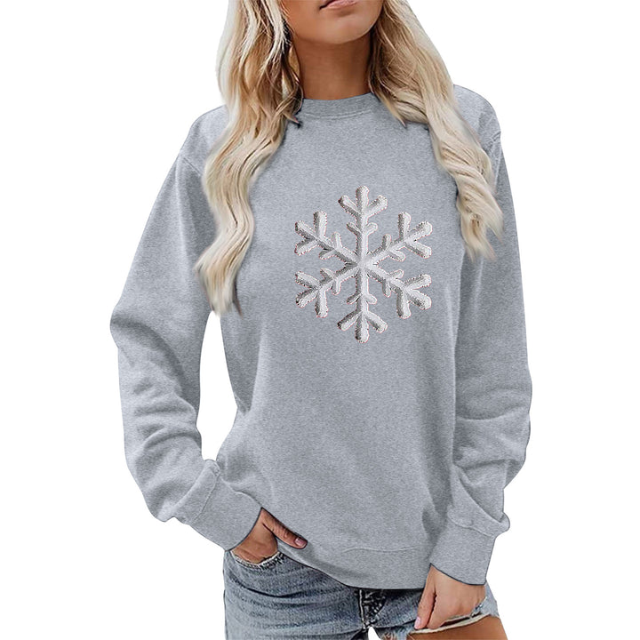Kvinnas sweatshirt med glittrande snöflinge design och avslappnad passform Mirla-Eva Jonsson