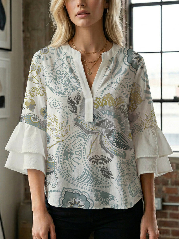 Kvinnblus med voluminösa rynkade ärmar och kreativt blommönster Mirla-Eva Jonsson