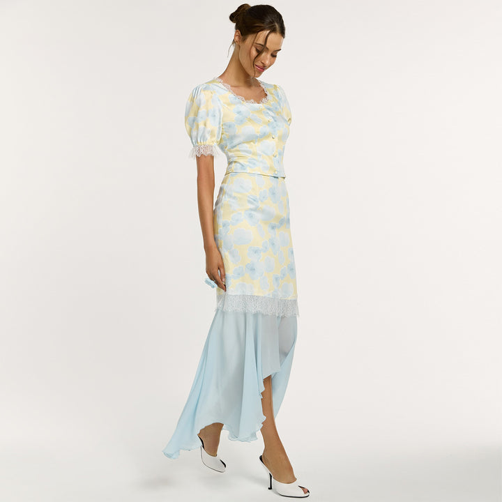Kvinno elegant klänning med asymmetrisk nederkant och blommönster Mirla-Eva Jonsson