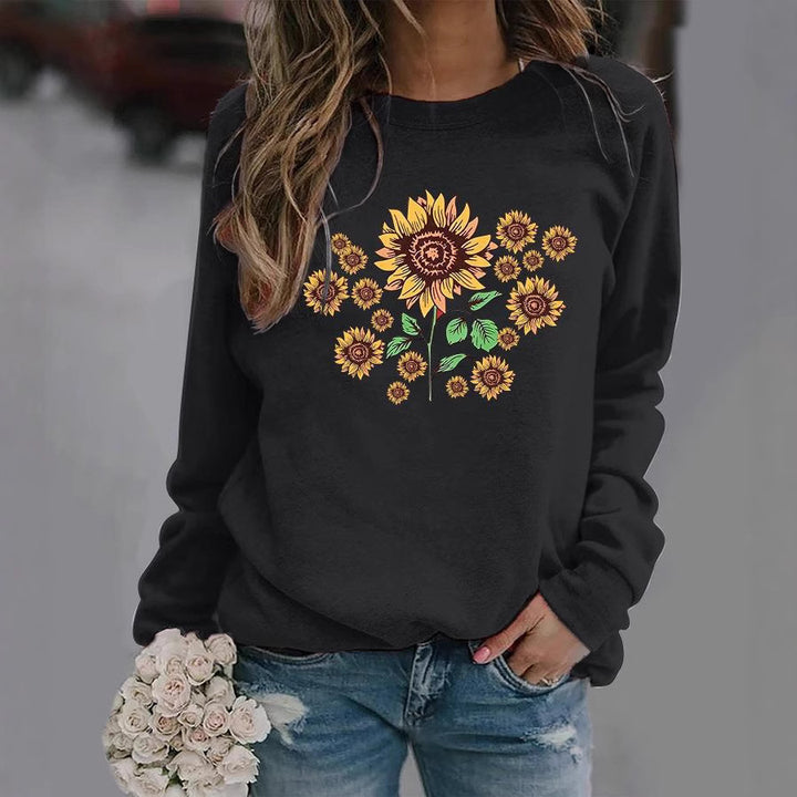 Kvinnohoodie med blommigt solrosmotiv och bekväm passform Mirla-Eva Jonsson