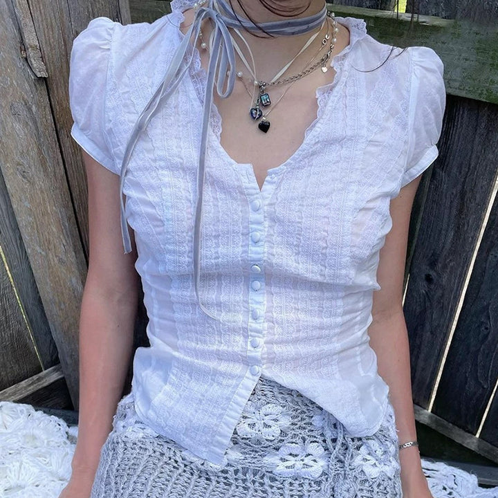 Kvinnor Elegant blusöverdel med volangdetaljer och knappslå Mirla-Eva Jonsson