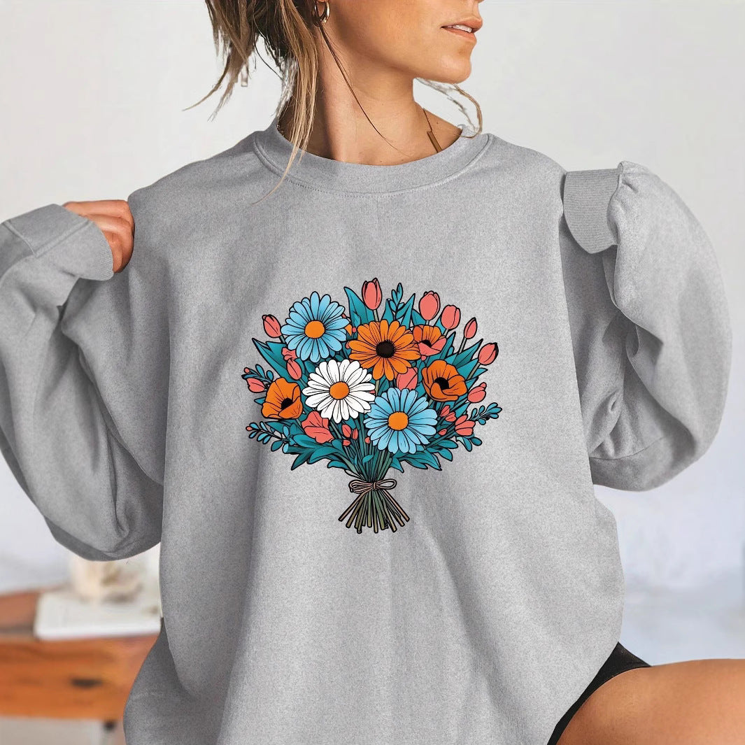 Kvinnors Oversized Sweatshirt med Blommiga Grafikdetaljer Mirla-Eva Jonsson