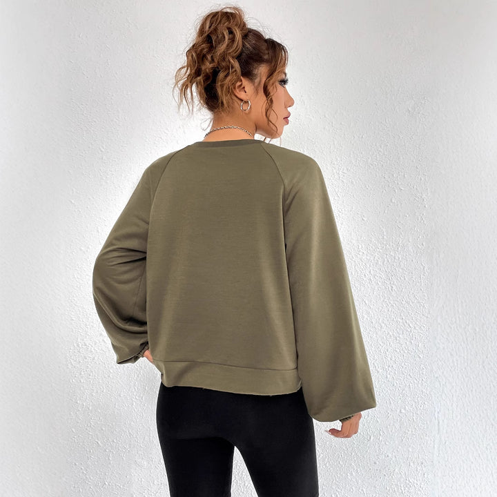 Kvinnors avslappnad raglan sweatshirt med elastiska muddar och minimalistisk design Mirla-Eva Jonsson