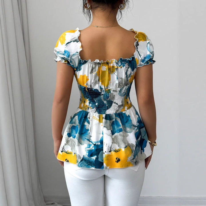 Kvinnors blus med blommiga volanger och elastisk midja Mirla-Eva Jonsson