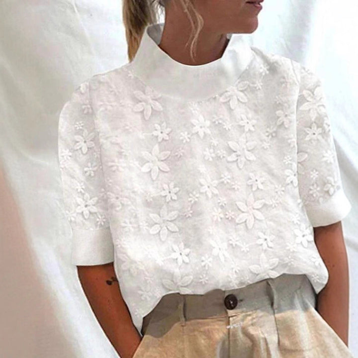 Kvinnors blus med blommigt broderidesign och kort skärning Mirla-Eva Jonsson
