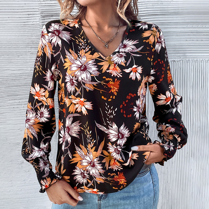 Kvinnors blus med blommönster och elastiska volangdetaljer Mirla-Eva Jonsson