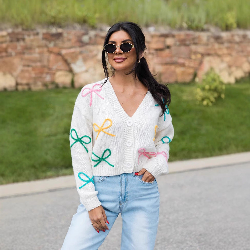 Kvinnors cardigan med lekfulla rosett-applikationer Mirla-Eva Jonsson