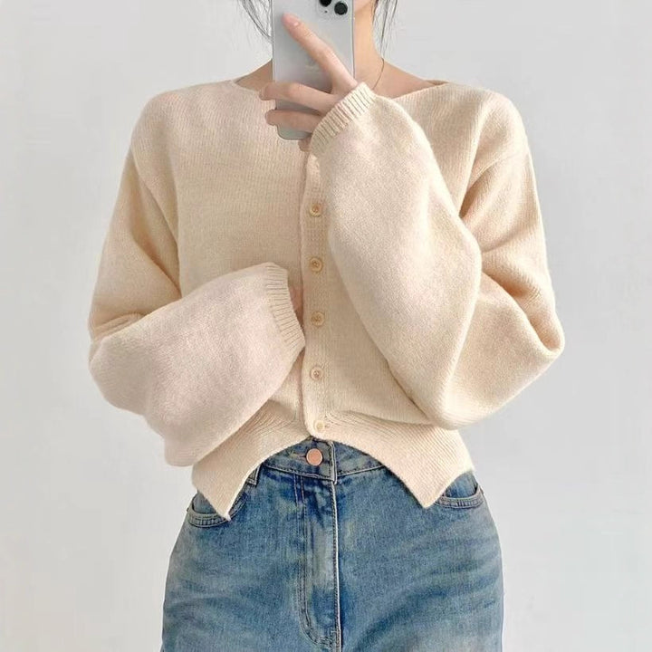 Kvinnors crop sweater med knappdetalj och oversized ärmar Mirla-Eva Jonsson