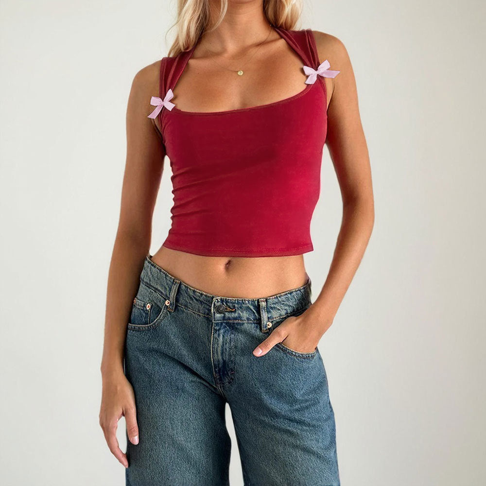Kvinnors crop top med justerbara spagetti axelband och lekfulla rosetter Mirla-Eva Jonsson