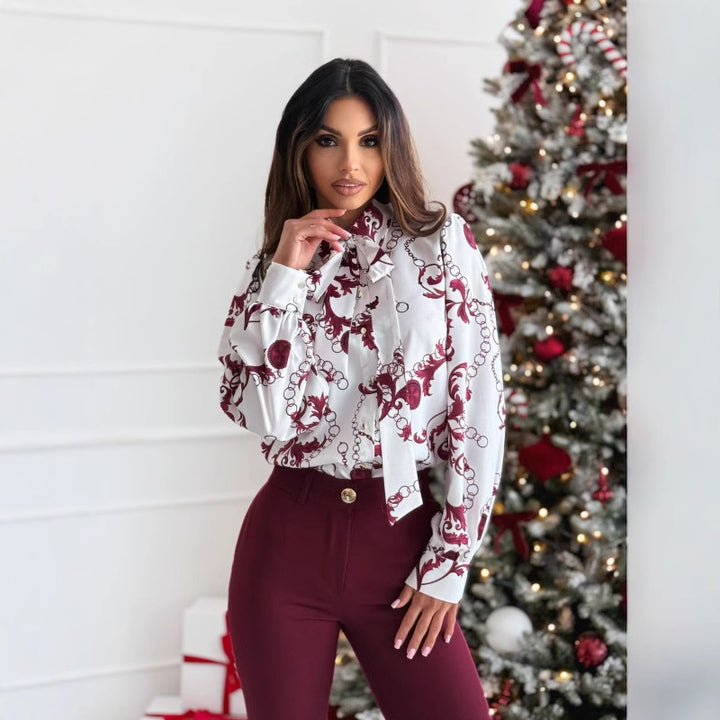 Kvinnors eleganta blus med dekorativ krage och blommönster Mirla-Eva Jonsson