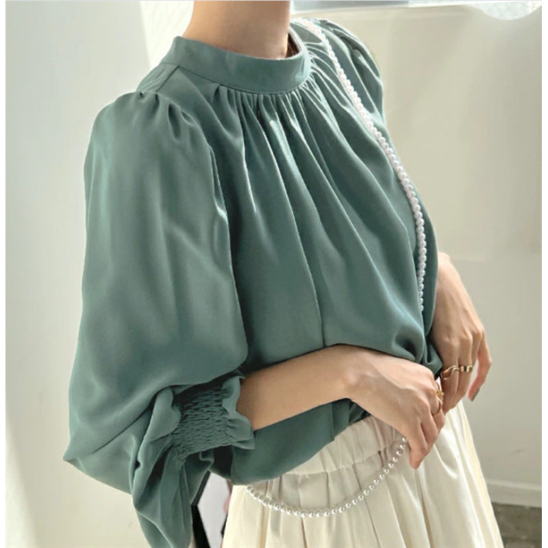 Kvinnors eleganta blus med voluminösa ärmar och ståkrage Mirla-Eva Jonsson