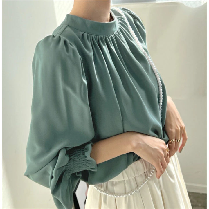 Kvinnors eleganta blus med voluminösa ärmar och ståkrage Mirla-Eva Jonsson