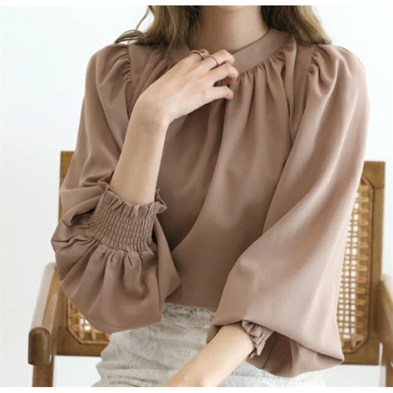 Kvinnors eleganta blus med voluminösa ärmar och ståkrage Mirla-Eva Jonsson