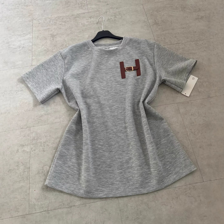 Kvinnors fashionabla t-shirt med unik logodetalj och avslappnad passform-Eva Jonsson
