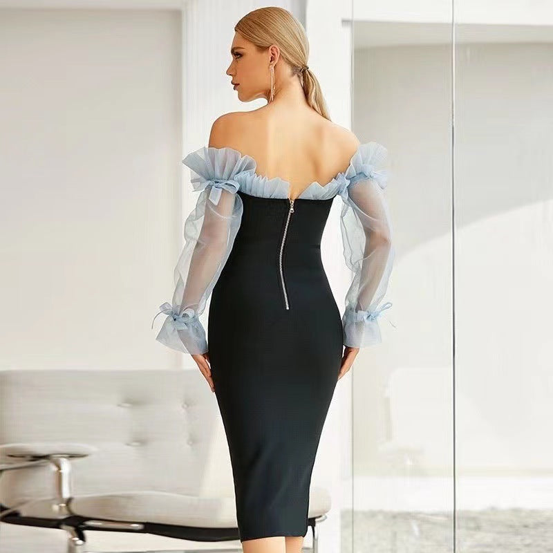 Kvinnors figurnära cocktailklänning med transparenta puffärmar och elegant V-ringning-Eva Jonsson