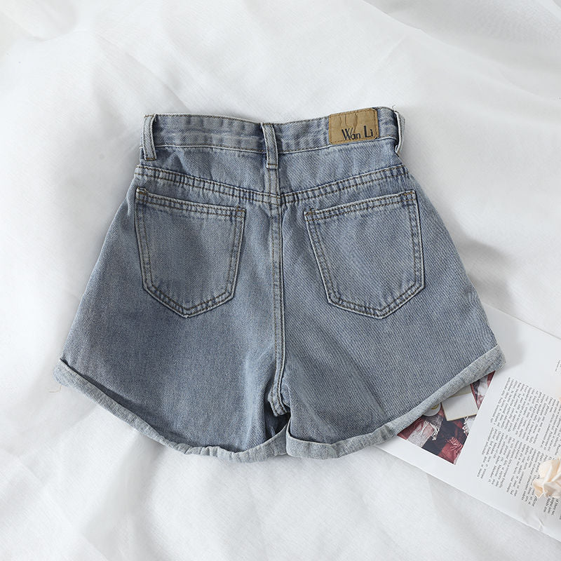 Kvinnors högmidjade denimshorts med konvertibel fåll och elastisk midja Mirla-Eva Jonsson