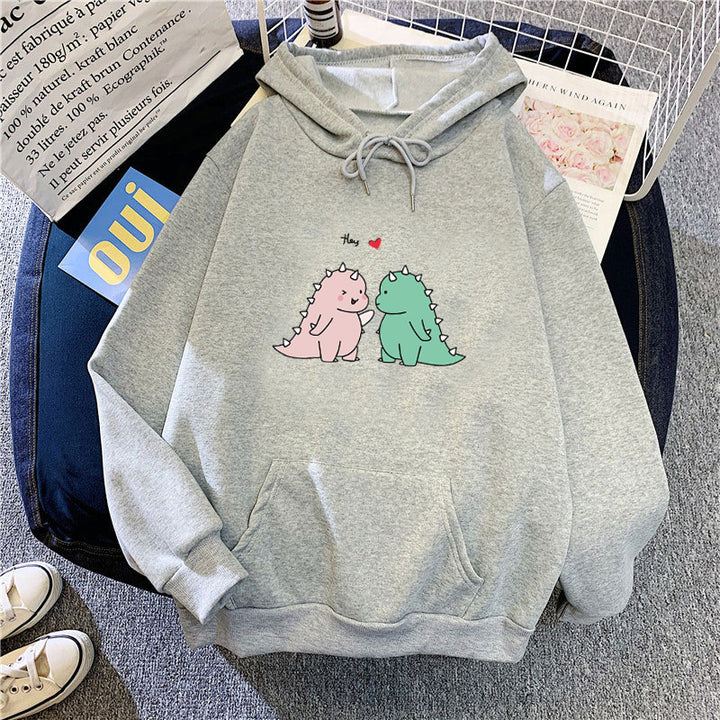 Kvinnors hoodie med lekfullt dinosaurmotiv Mirla-Eva Jonsson