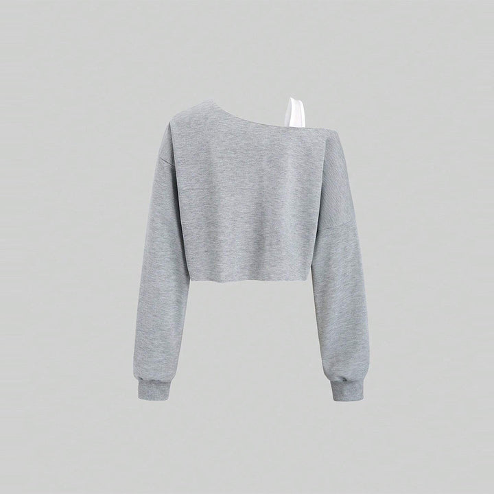 Kvinnors kortad sweatshirt med asymmetrisk design och voluminösa ärmar Mirla-Eva Jonsson