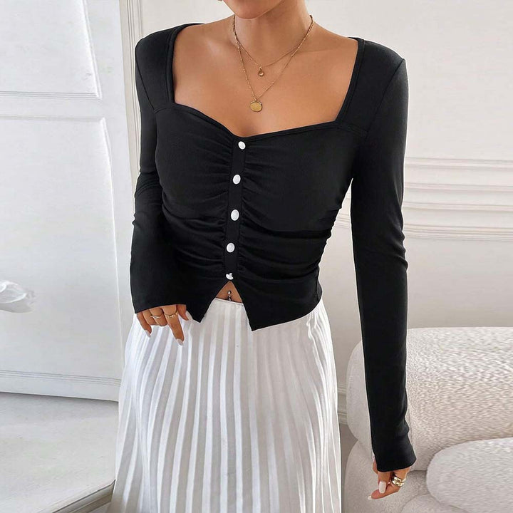 Kvinnors långärmad crop top med dekorativ knappdetalj och rynkad design Mirla-Eva Jonsson