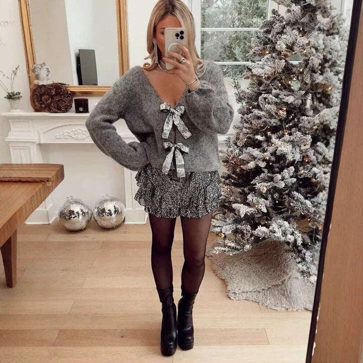 Kvinnors lösa stickade kofta med eleganta rosett detaljer Mirla-Eva Jonsson