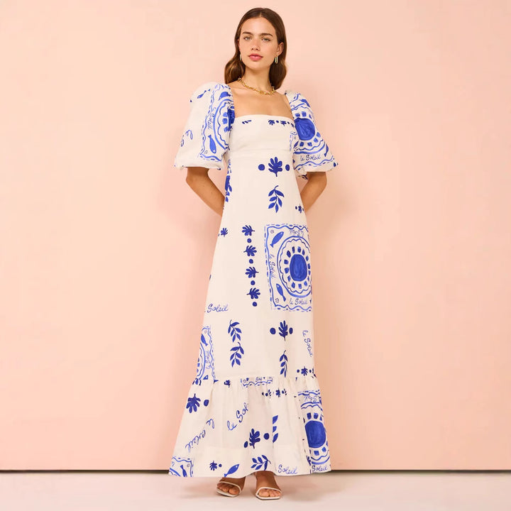 Kvinnors maxi klänning med eleganta puffärmar och blommiga detaljer Mirla-Eva Jonsson