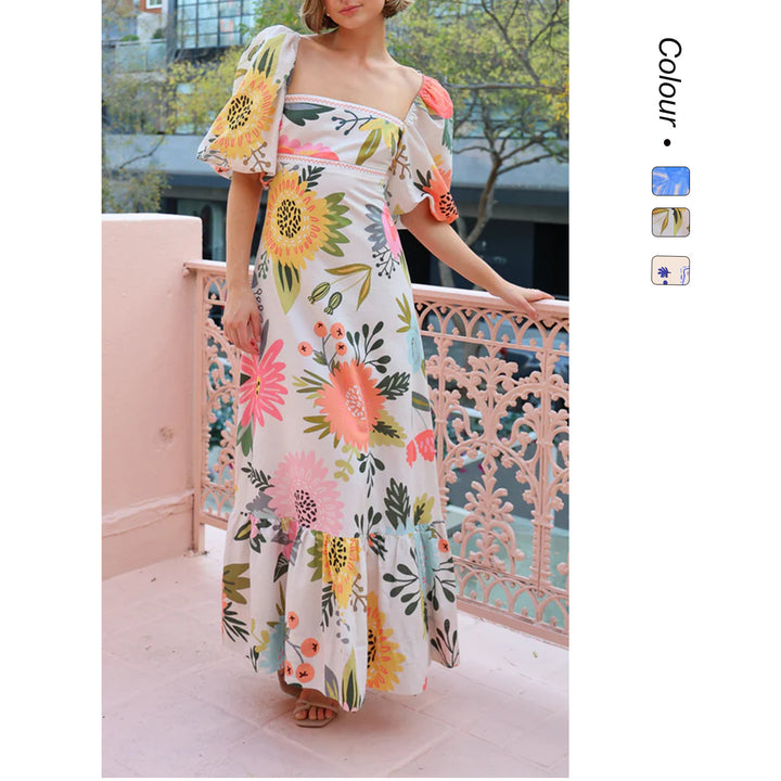Kvinnors maxi klänning med eleganta puffärmar och blommiga detaljer Mirla-Eva Jonsson