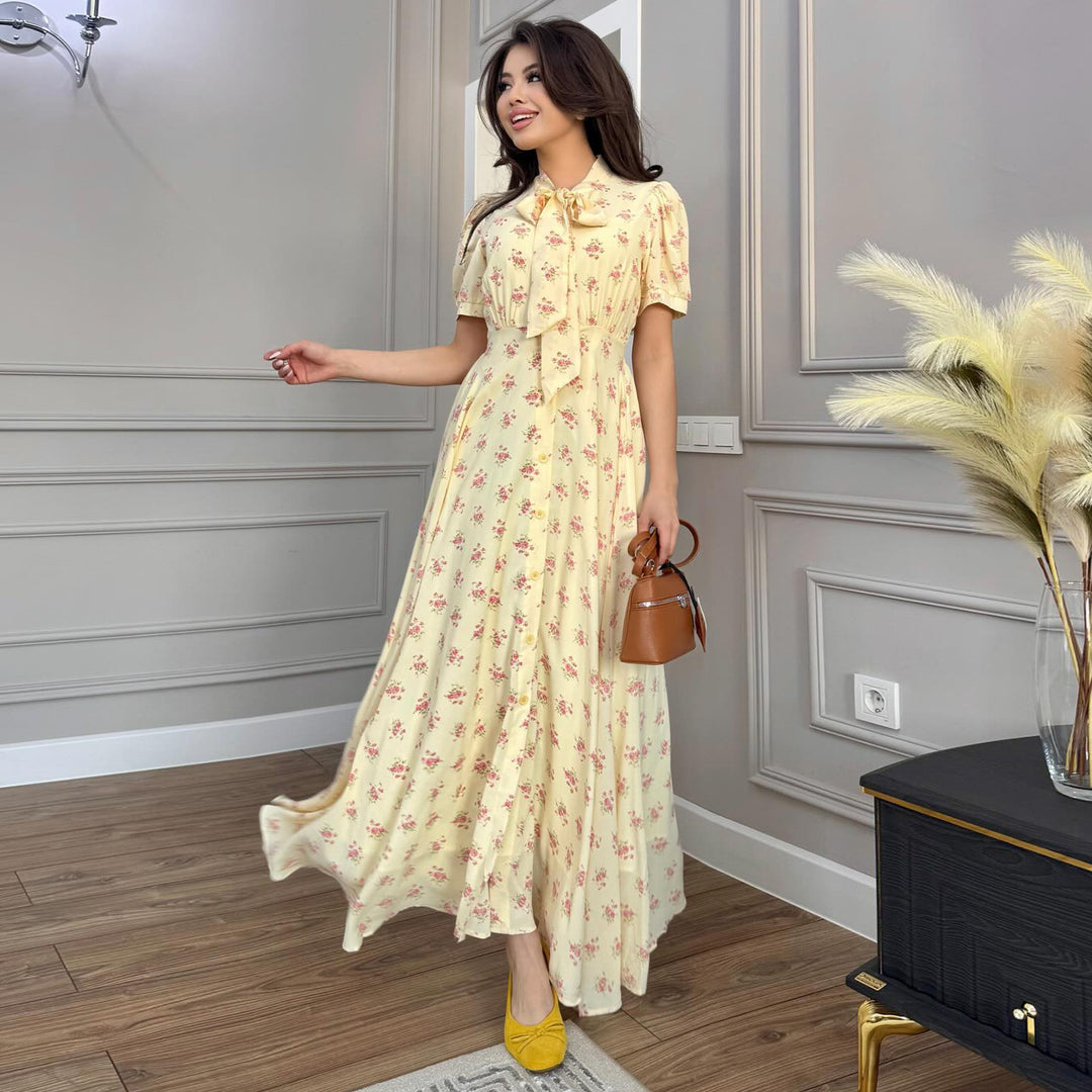 Kvinnors maxiklänning med elegant rosett och romantiskt blommönster Mirla-Eva Jonsson