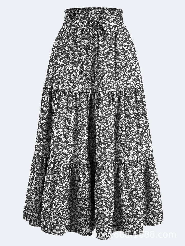 Kvinnors midijurk med elastiskt midjeband och blommönster Mirla-Eva Jonsson