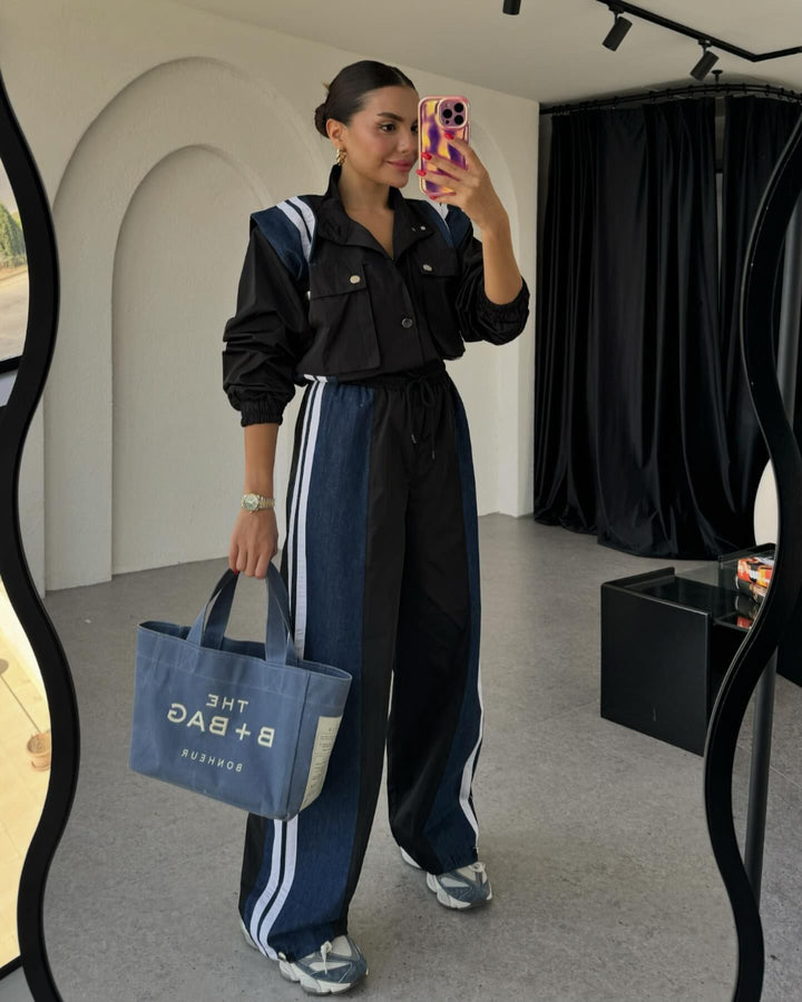 Kvinnors sportiga jumpsuit med sofistikerad dragsko midja och kontrasterande ränder Mirla-Eva Jonsson
