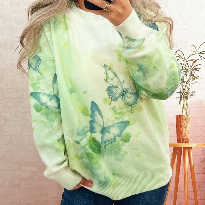 Kvinnors stickad pullover med skimrande fjäril-applikationer Mirla-Eva Jonsson