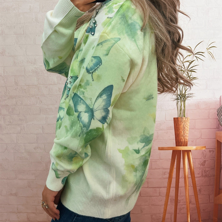 Kvinnors stickad pullover med skimrande fjäril-applikationer Mirla-Eva Jonsson