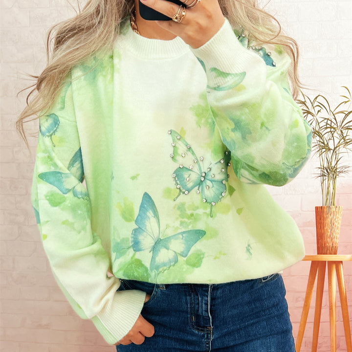 Kvinnors stickad pullover med skimrande fjäril-applikationer Mirla-Eva Jonsson