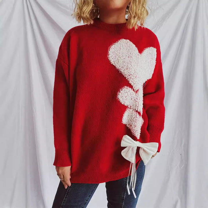 Kvinnors stickad tröja med charmigt hjärtformad design och dekorativ rosett Mirla-Eva Jonsson
