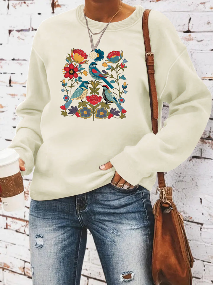 Kvinnors sweatshirt med blommigt fågelmotiv och avslappnad passform Mirla-Eva Jonsson