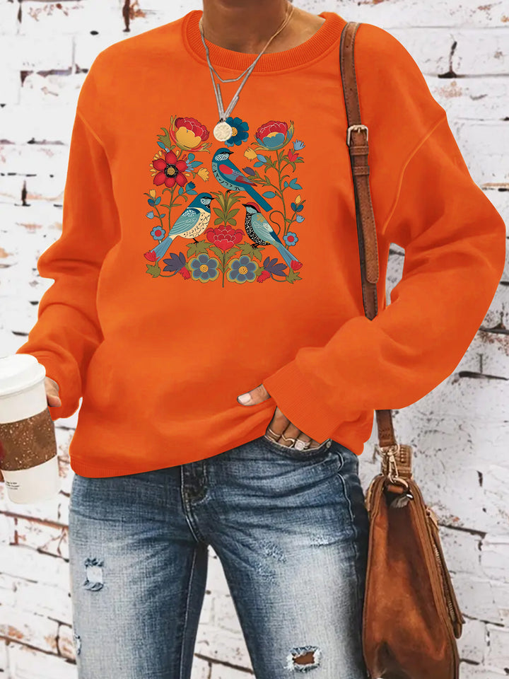 Kvinnors sweatshirt med blommigt fågelmotiv och avslappnad passform Mirla-Eva Jonsson