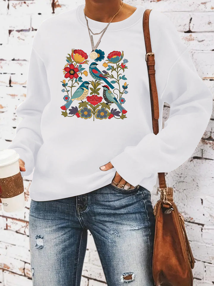 Kvinnors sweatshirt med blommigt fågelmotiv och avslappnad passform Mirla-Eva Jonsson
