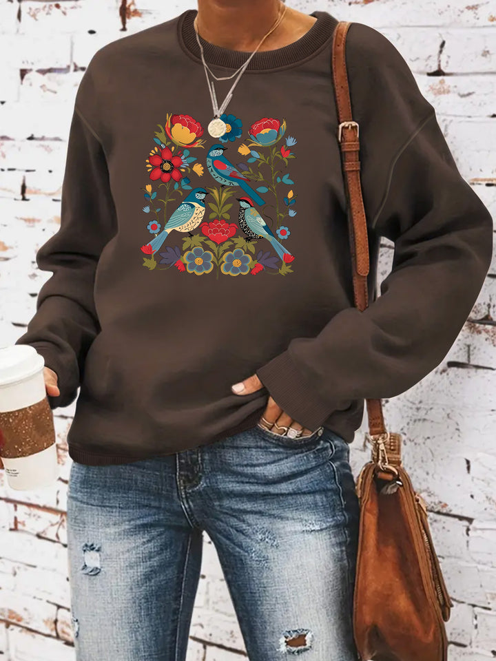 Kvinnors sweatshirt med blommigt fågelmotiv och avslappnad passform Mirla-Eva Jonsson