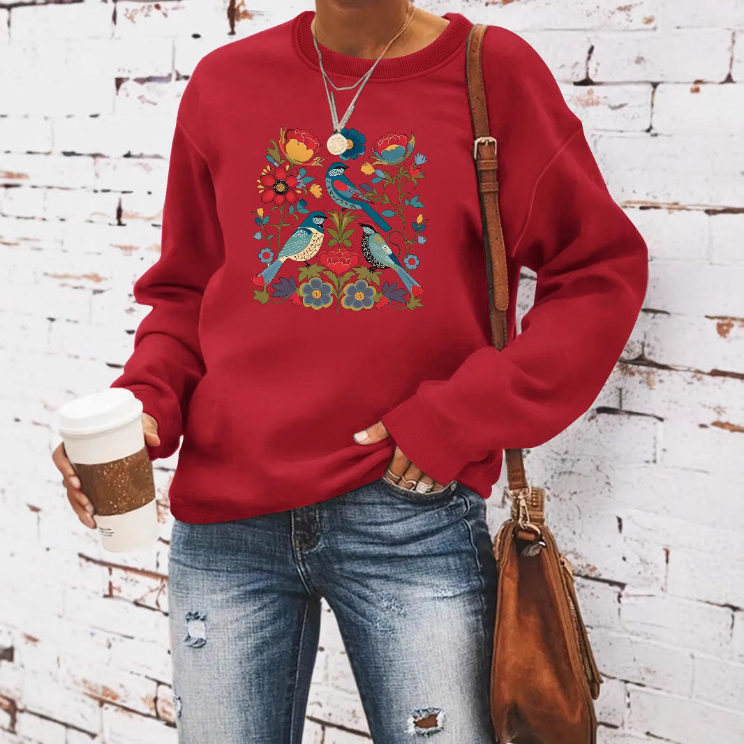 Kvinnors sweatshirt med blommigt fågelmotiv och avslappnad passform Mirla-Eva Jonsson