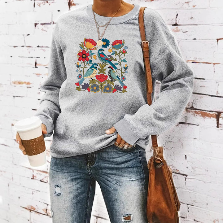 Kvinnors sweatshirt med blommigt fågelmotiv och avslappnad passform Mirla-Eva Jonsson