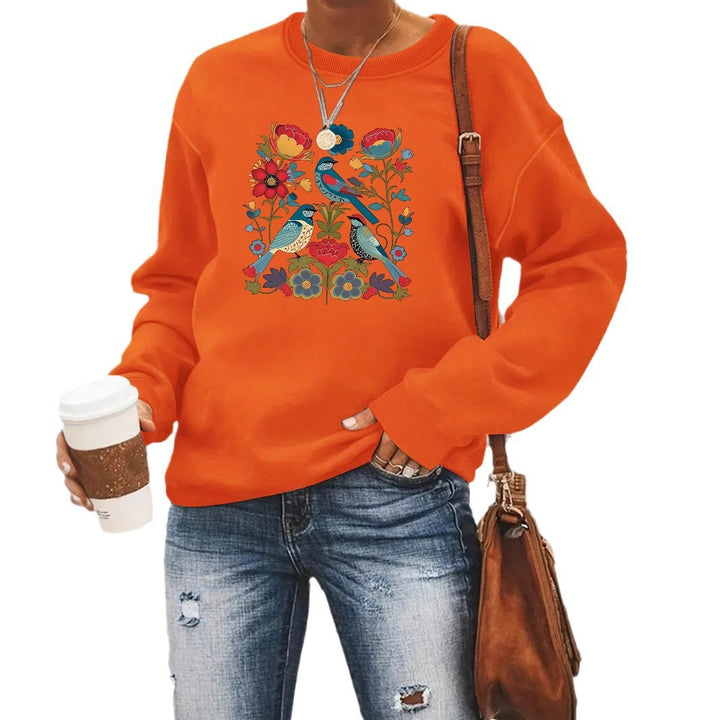 Kvinnors sweatshirt med blommigt fågelmotiv och avslappnad passform Mirla-Eva Jonsson