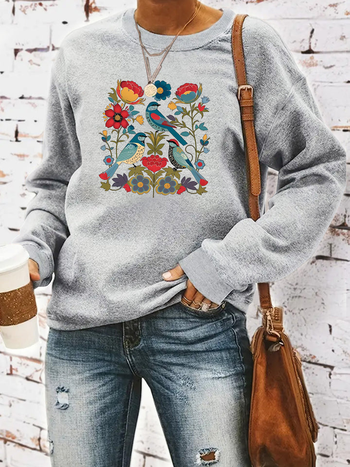 Kvinnors sweatshirt med blommigt fågelmotiv och avslappnad passform Mirla-Eva Jonsson