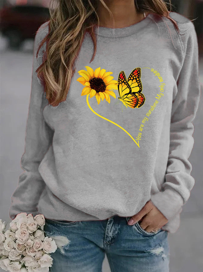 Kvinnors sweatshirt med grafisk fjäril och solrosmotiv Mirla-Eva Jonsson