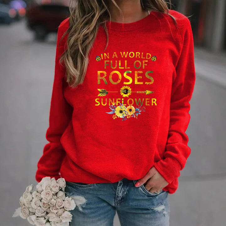 Kvinnors sweatshirt med inspirerande design och blommig dekorering Mirla-Eva Jonsson