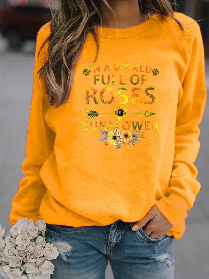 Kvinnors sweatshirt med inspirerande design och blommig dekorering Mirla-Eva Jonsson