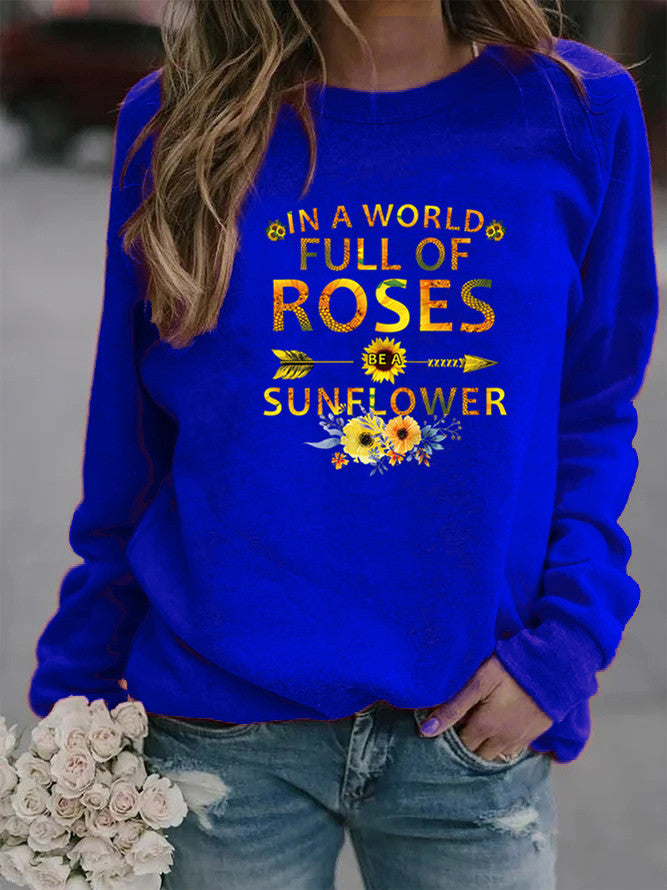 Kvinnors sweatshirt med inspirerande design och blommig dekorering Mirla-Eva Jonsson