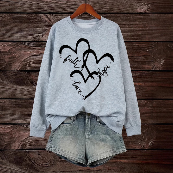 Kvinnors sweatshirt med romantiskt hjärtmotiv och inspirerande tryck Mirla-Eva Jonsson