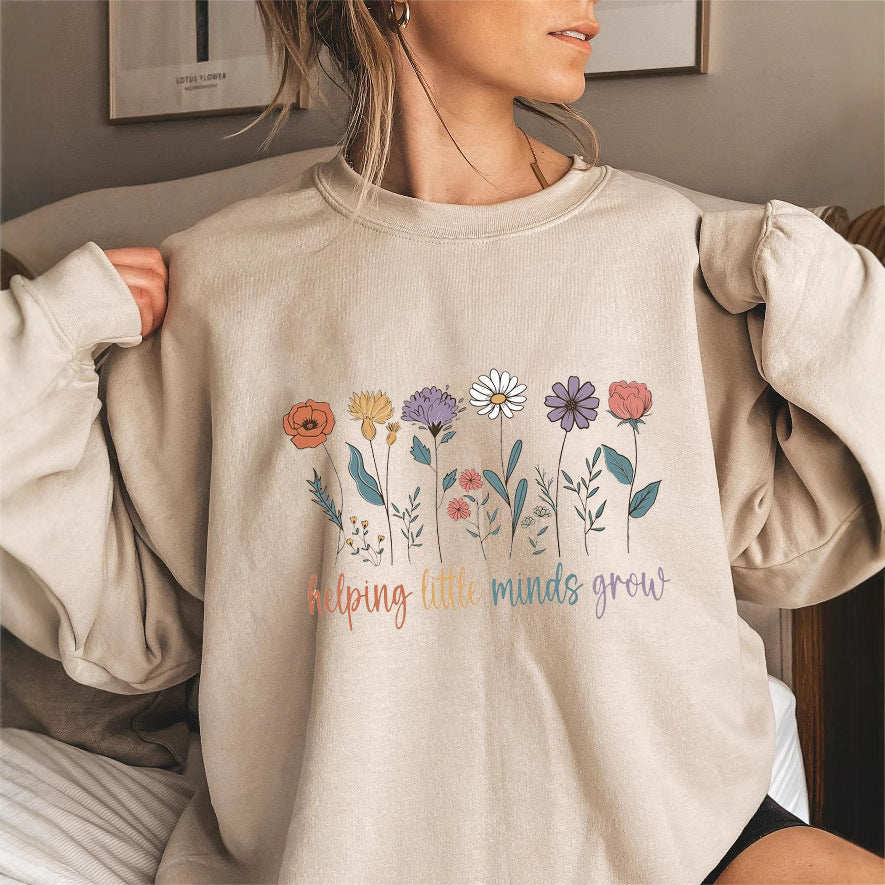 Kvinnors sweatshirt med voluminösa ärmar och motiverande blommönster Mirla-Eva Jonsson