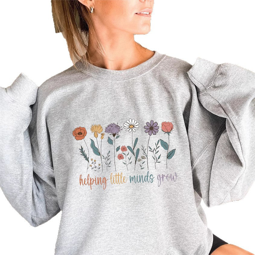 Kvinnors sweatshirt med voluminösa ärmar och motiverande blommönster Mirla-Eva Jonsson