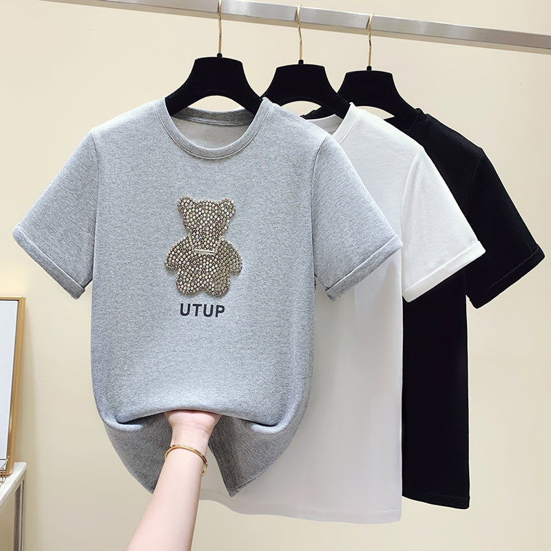 Kvinnors t-shirt med glittrande björnmotiv och avslappnad passform Mirla-Eva Jonsson
