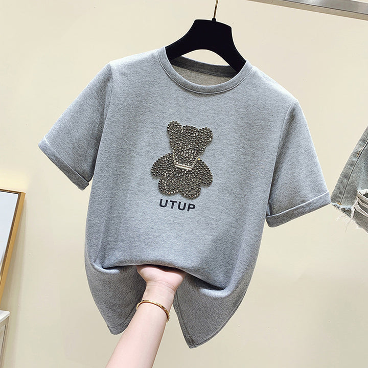 Kvinnors t-shirt med glittrande björnmotiv och avslappnad passform Mirla-Eva Jonsson